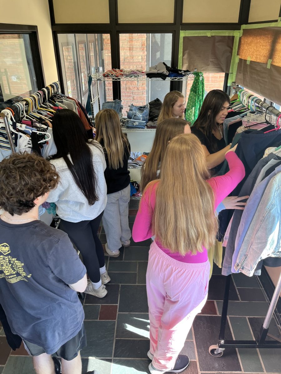 Student shopping for new clothes at the Swap Shop