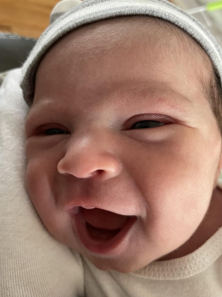 Hudson smiling as only a newborn can.