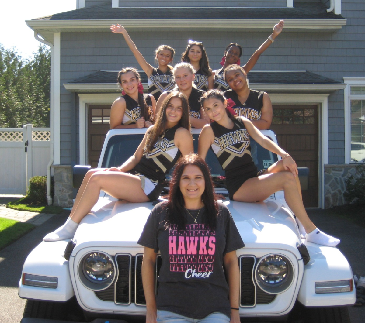 Ms. Schiff and some of her cheerleaders before being shooed off a local's driveway.