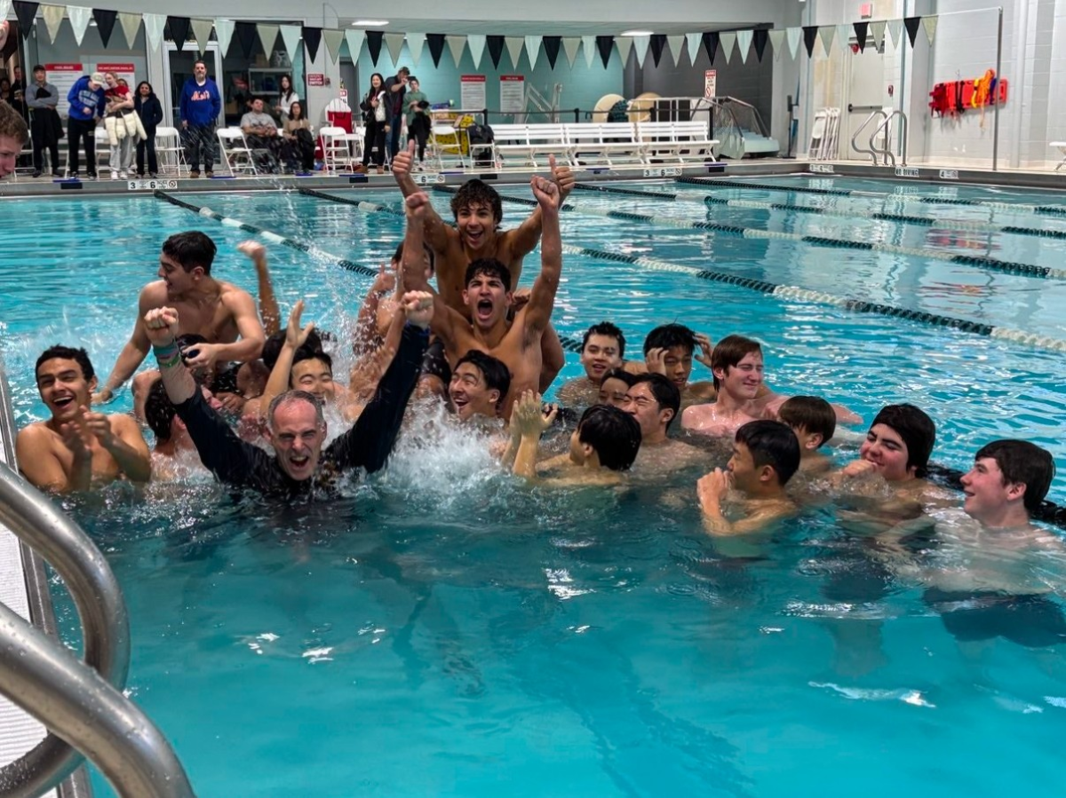 Coach Armen is plunged into the pool in celebration.