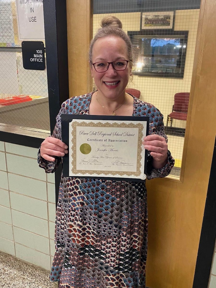 Not a mug shot, Mrs. Cuccio proudly holds up her award celebrating her 25th year of service to RDHS.