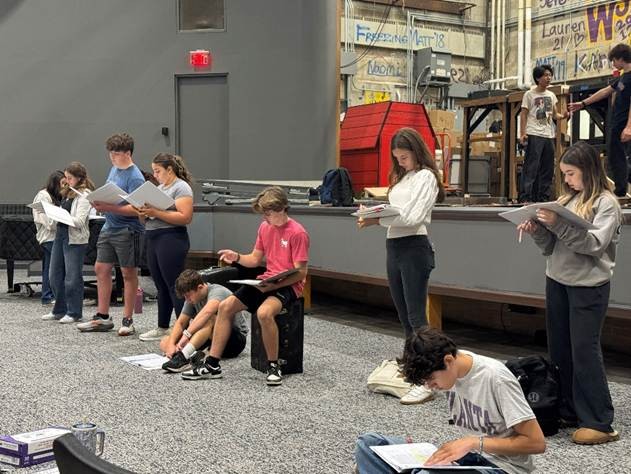 The cast blocks the opening scene in the newly renovated auditorium.