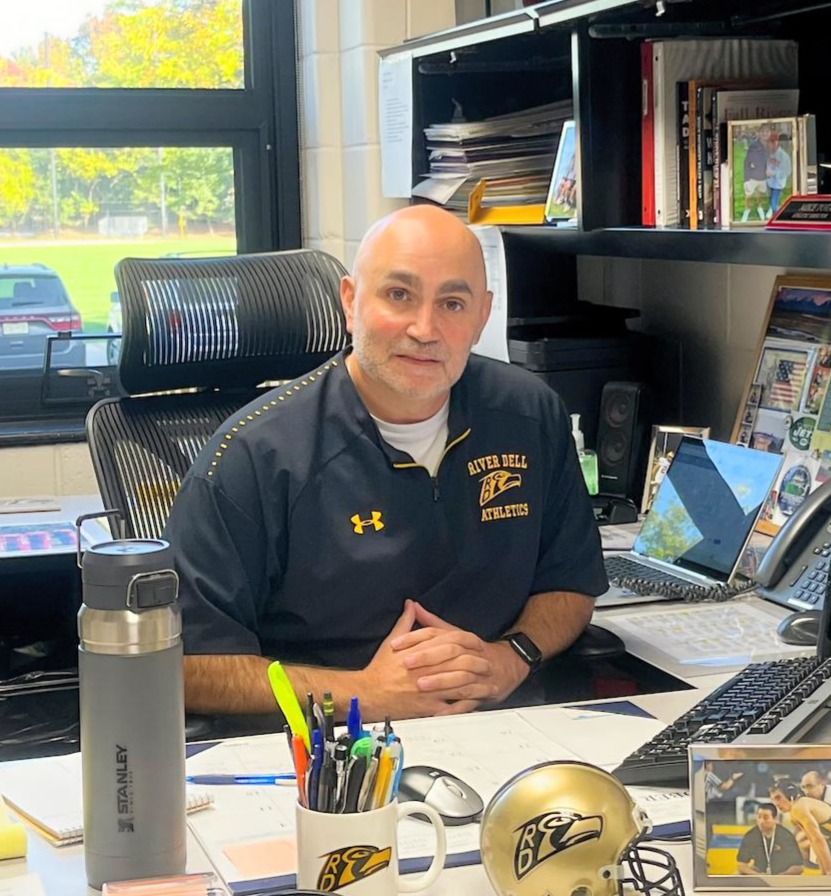 Mr. Tota behind the Resolute desk.