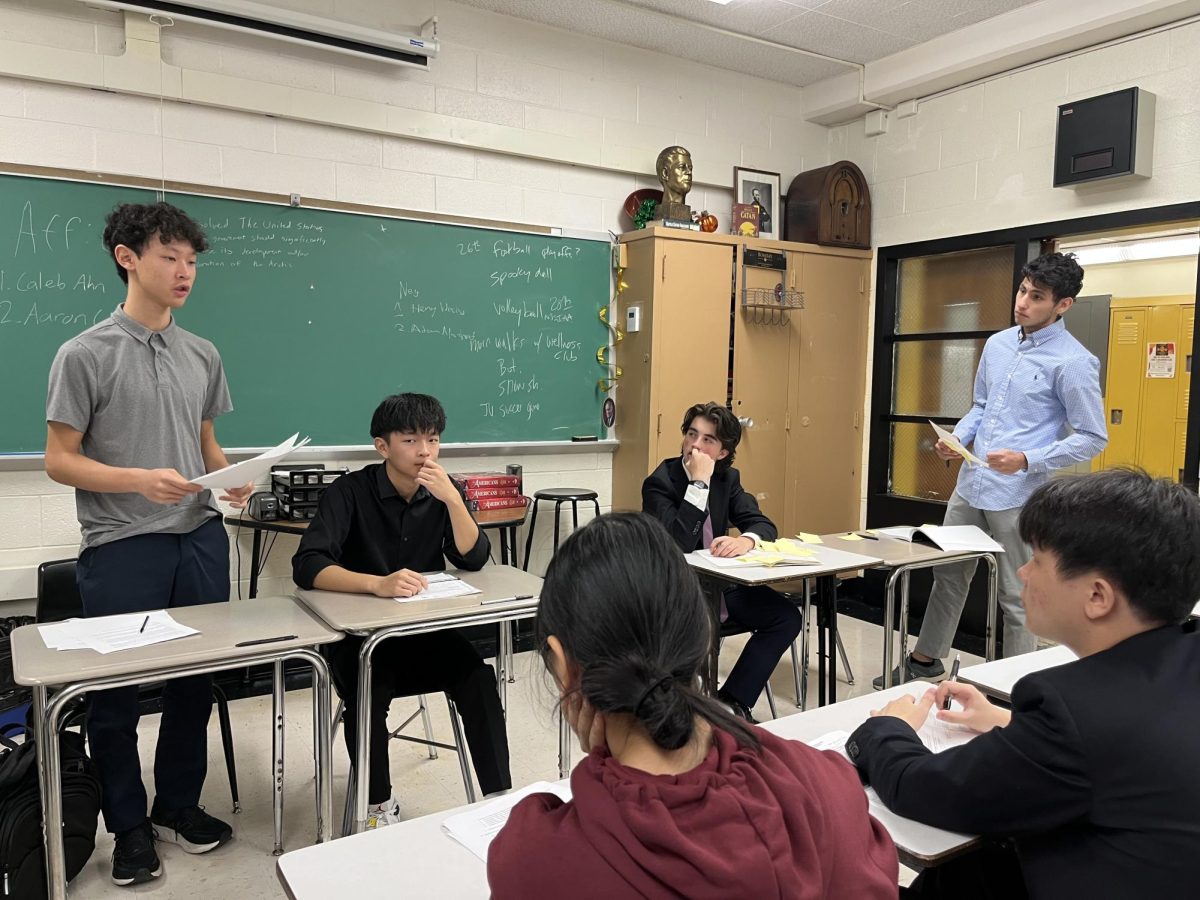 Henry Wacks, seated right, locks in as his opponent deliver their opening.