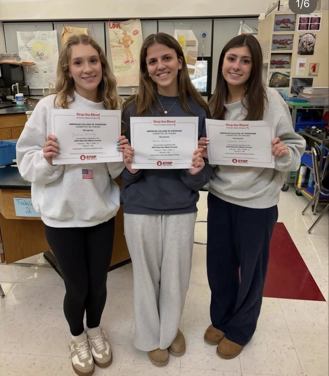 Julia Carey, Anna Fikaris, and Bella Reina pose with the certificates they earned at the event (left to right).